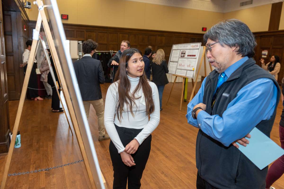 female student talking to male professor sharing research